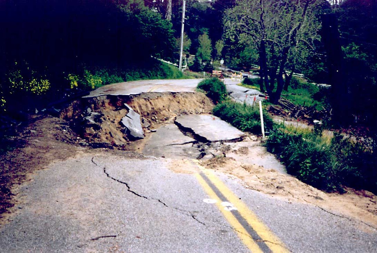 A section of road that has slipped downhill, leaving a car-size void